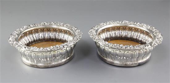 A pair of George IV silver wine coasters, Diameter 6 ¾”/170mm Height 60 Total weight inc bases 19.6ozs/557grs